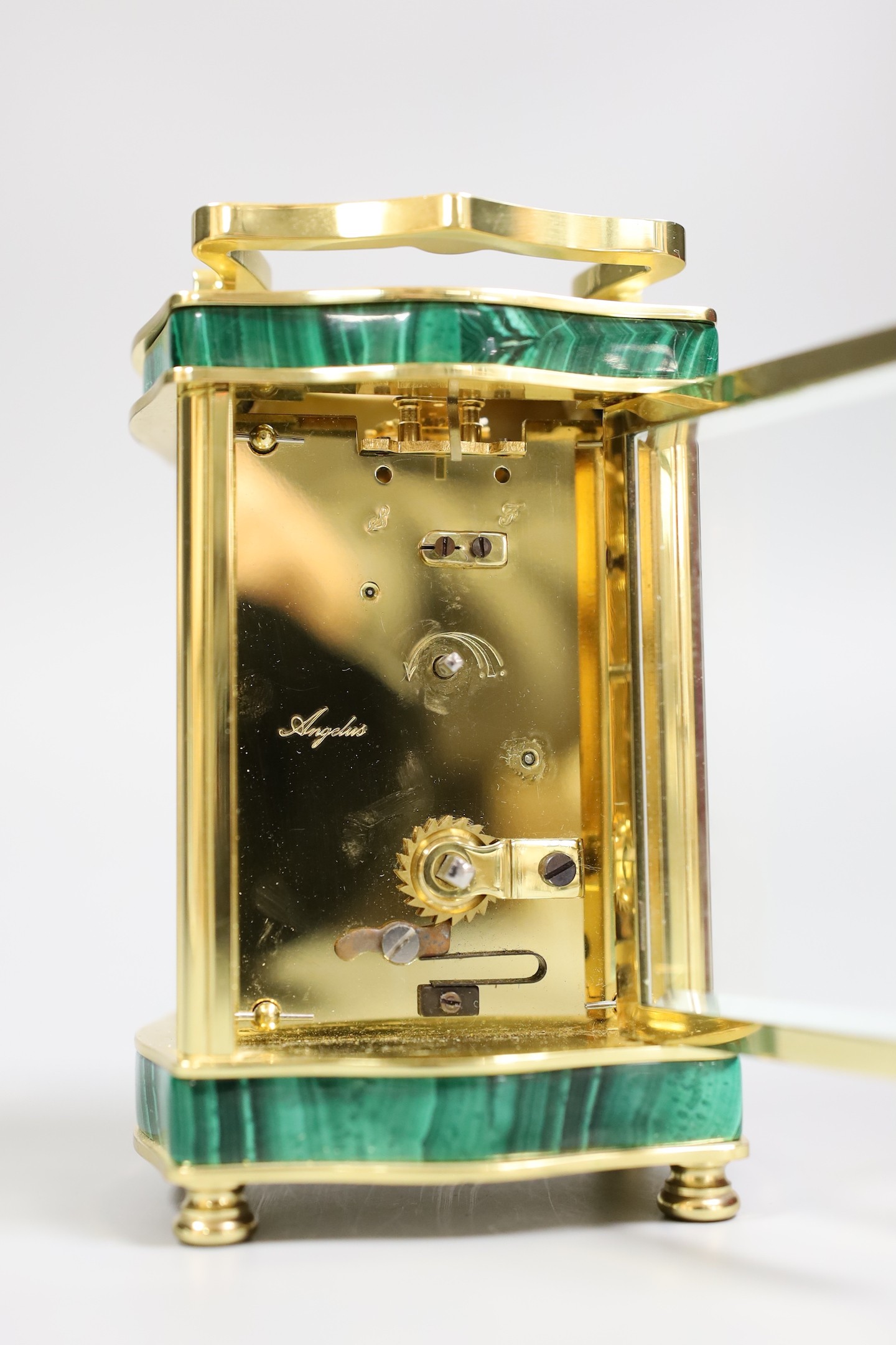 An Asprey carriage timepiece with key, 12 cms high, and an Asprey presentation box